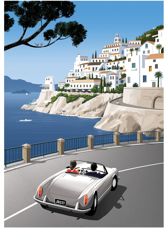 A silver convertible takes a cliff road above a white town and a blue bay