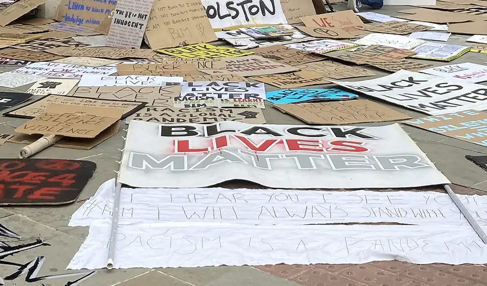Placards on the ground around the empty plinth in Bristol, 7 June 2020